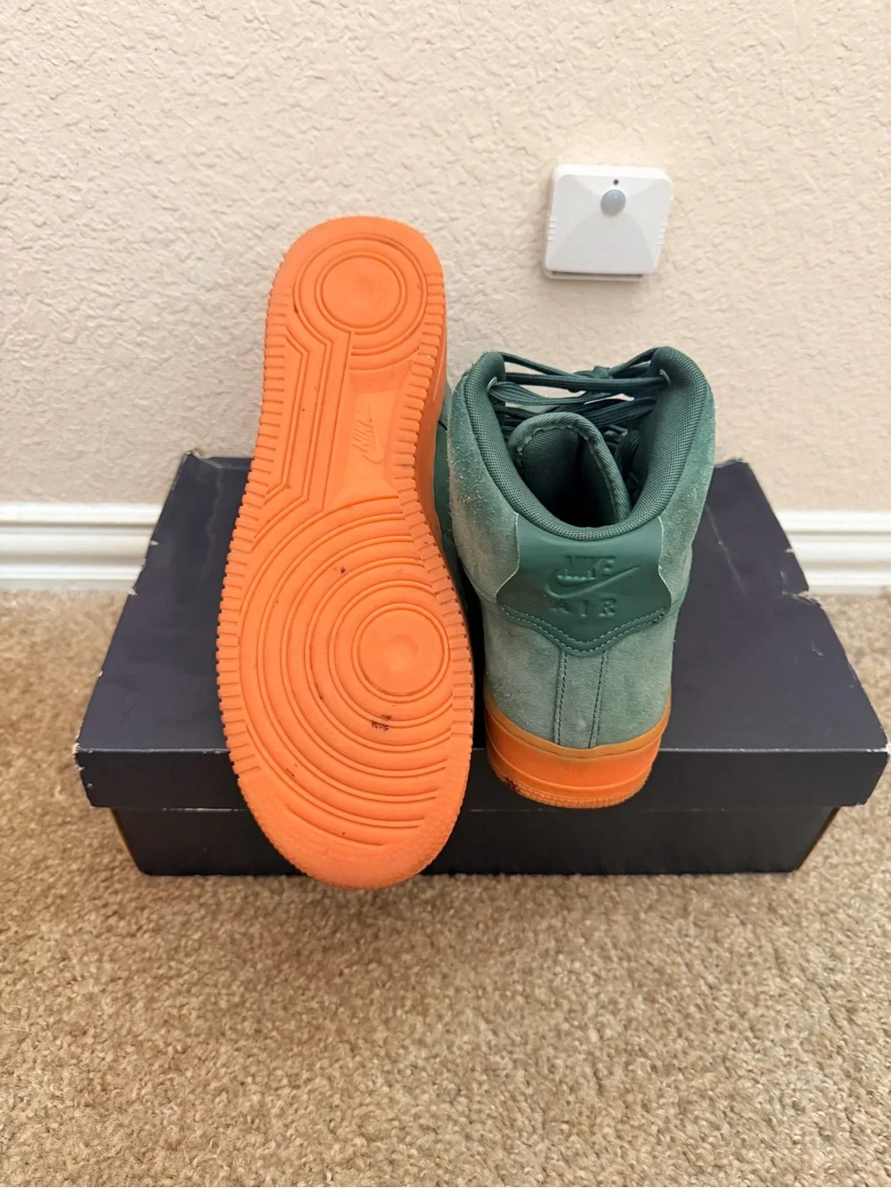 Shoebox on floor under wall sensor